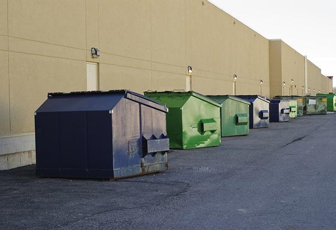 a row of large construction dumpsters on-site in Advance